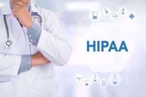 The word HIPAA and medical icons float in the foreground next to an image of a medical professional in a white jacket and wearing a stethoscope.