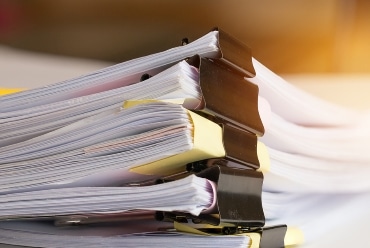 Stack of Paper documents with clip, Pile of unfinished documents on office desk folders