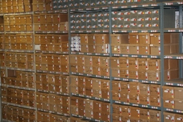a large quantity of boxes are stored on racks at this records storage warehouse facility