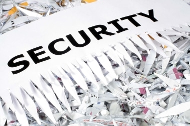 Paper labeled “SECURITY” being shredded into strips.